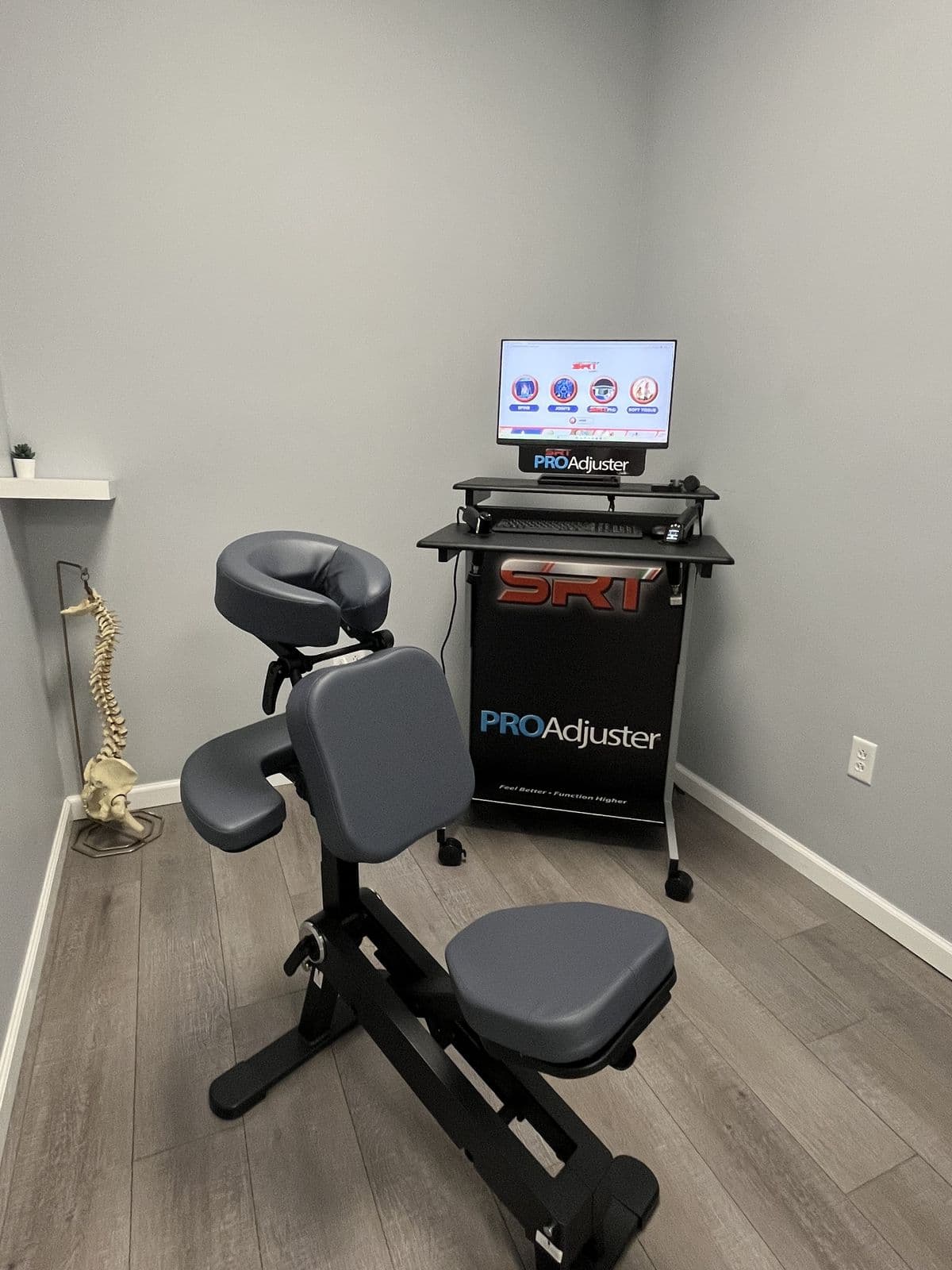 The ProAdjuster SRT room at Omni's West Haven office — a computerized, instrument-assisted adjustment system with its patient screen on